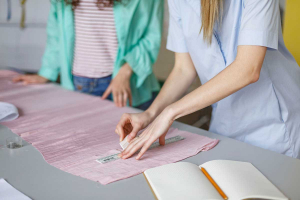 two designers in studio working with fabric