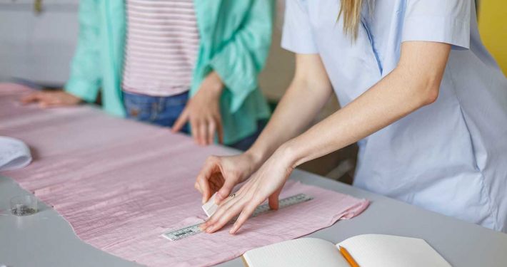 two designers in studio working with fabric