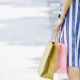woman in blue and white skirt with shopping bags